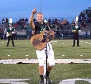 No one wanted to sing the national anthem, so one high school student took off his helmet and grabbed up a guitar.
